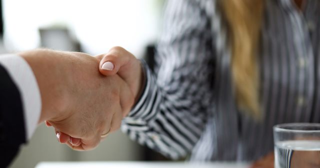 Man and woman shaking hands after productive deliberations